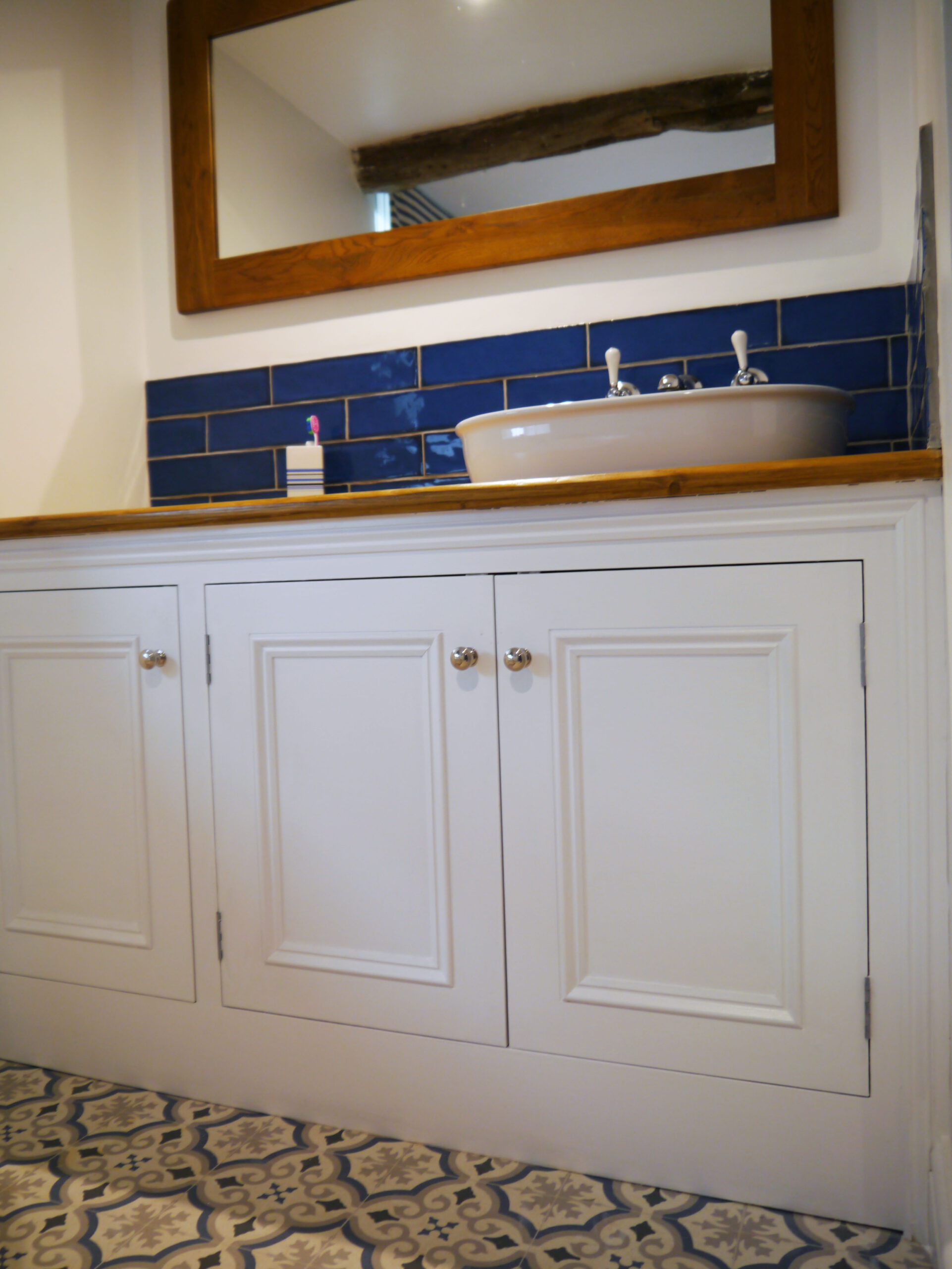 Bespoke white bathroom sink units by Kings Stag Joinery