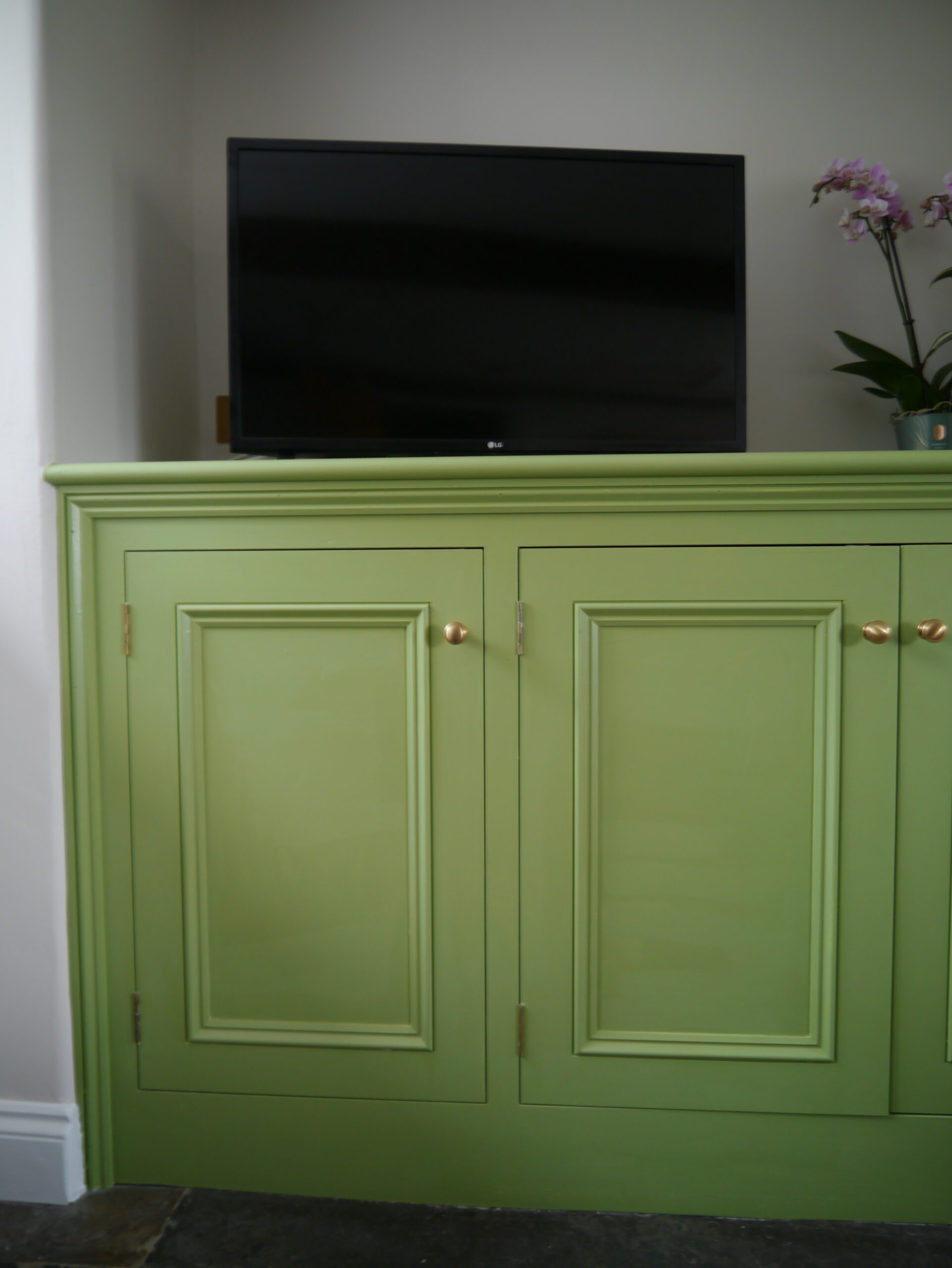 Bespoke green timber TV unit by Kings Stag Joinery