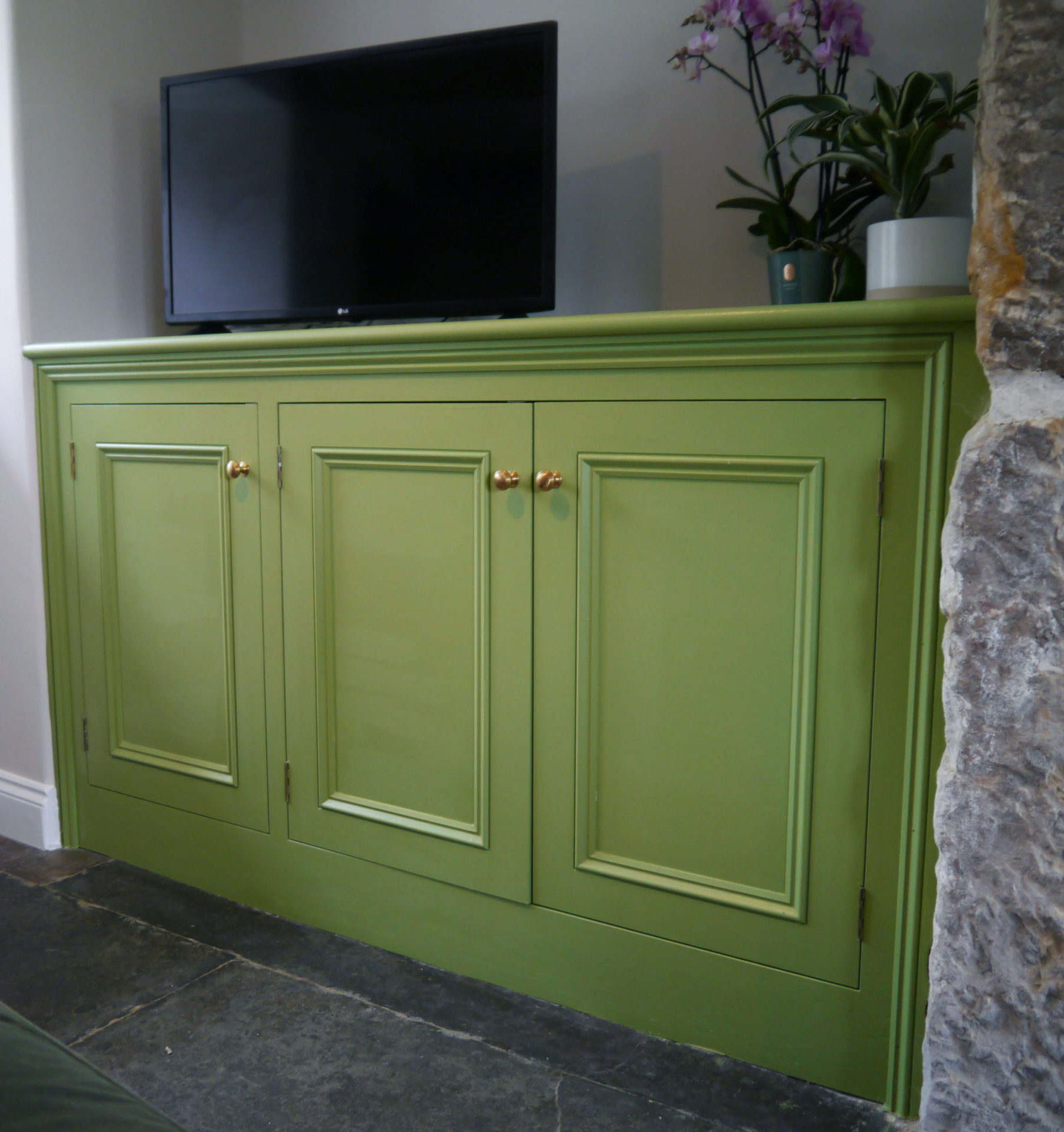 Bespoke green timber TV unit by Kings Stag Joinery